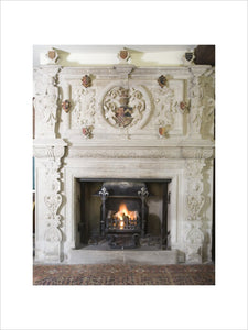 The heraldic stone chimneypiece in the Great Hall at Baddesley Clinton, West Midlands
